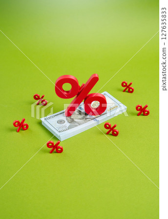 A stack of dollar bills under the pressure of interest. Inflation. High tax pressure. Debt 127635833