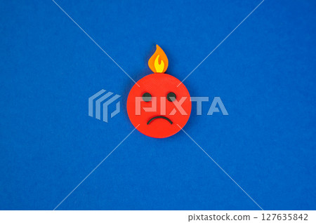An evil face and fire on the head. A metaphor for a nervous breakdown and burnout An evil face and fire on the head. A metaphor for a nervous breakdown and burnout 127635842