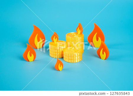 A pile of coins surrounded by fire. Danger of losing savings. Inflation, confiscation of savings. A pile of coins surrounded by fire. Danger of losing savings. Inflation, confiscation of savings. 127635843