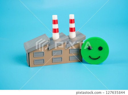 Factory building and smiling emoji. Good investment climate. Excellent economic health 127635844