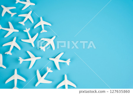 Passenger airplane figurines and space for text. Civil flights. Commercial flights Passenger airplane figurines and space for text. Civil flights. Commercial flights 127635860