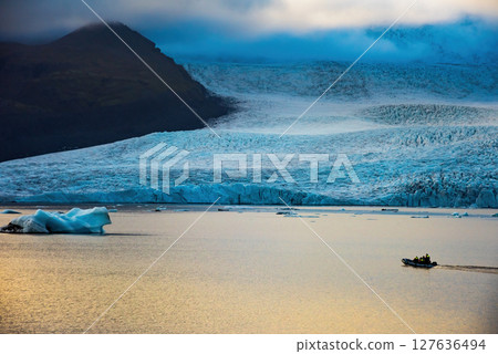 Glacier and icebergs in Fjallsarlon Glacial Lagoon, Iceland. Great tourist attraction Glacier and icebergs in Fjallsarlon Glacial Lagoon, Iceland. Great tourist attraction 127636494
