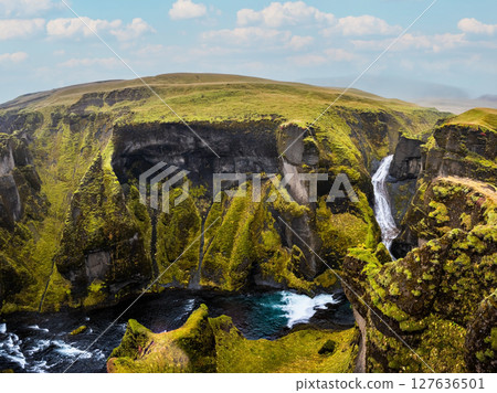 Unique landscape of Fjadrargljufur in Iceland. Top tourism destination. Fjadrargljufur Canyon is a massive canyon about 100 meters deep, located in South East of Iceland. Unique landscape of Fjadrargljufur in Iceland. Top tourism destination. Fjadrargljufur Canyon is a massive canyon about 100 meters deep, located in South East of Iceland. 127636501