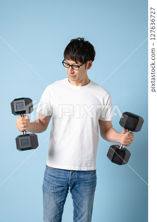 Men doing muscle training with dumbbells Men doing muscle training with dumbbells 127636727