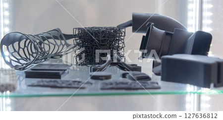 Different plastic models printed on 3D printer from powder. Objects created on 3D printer from polyamide powder. New 3D printing technology. Modern additive progressive 3D printing technologies. MJF 127636812