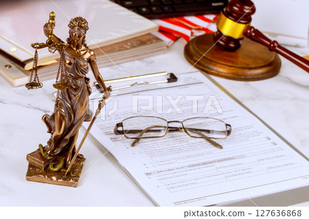 Statue of Lady Justice stands holding scales Justice gavel serious atmosphere reflects legal authority impartiality in office 127636868