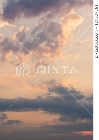 cumulus clouds on the sky blown by the wind. sundown stormy. cloudy weather meteorology background in orange glow. evening mood cumulus clouds on the sky blown by the wind. sundown stormy. cloudy weather meteorology background in orange glow. evening mood 127637361