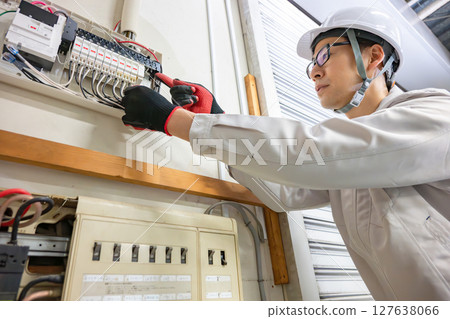 Male worker doing electrical work 127638066