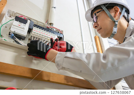 Male worker doing electrical work 127638067