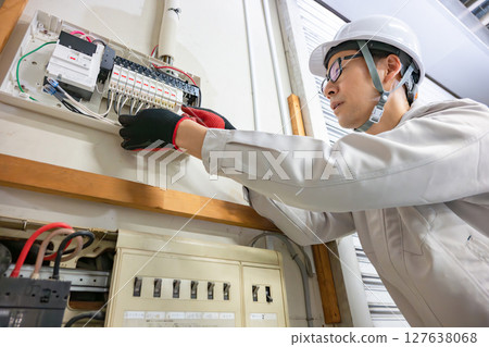 Male worker doing electrical work 127638068