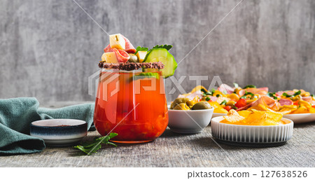 Snacktails with a cheese, salami, olive and vegatables  in a glass on the table web banner 127638526