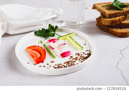 Concept diet on a plate of low-calorie foods on the table Concept diet on a plate of low-calorie foods on the table 127638528