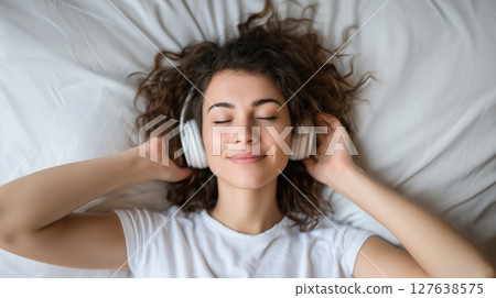 Mental wellness and meditation featuring calm woman with peaceful expression and music 127638575