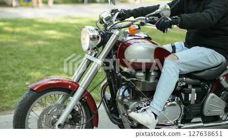 Retro Red Silver Motorcycle Rides through Park Retro Red Silver Motorcycle Rides through Park 127638651