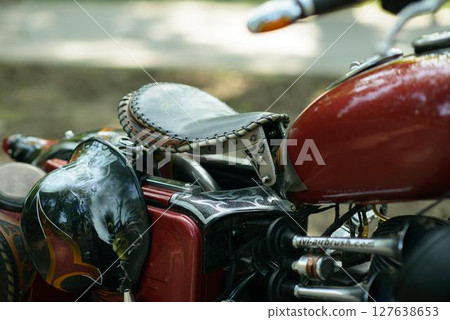 Red Bobber Motorcycle Detail with Leather Seat 127638653