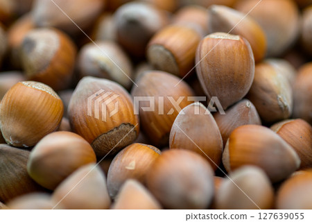 Macro closeup view of pile of raw shelled Hazelnuts, healthy food 127639055