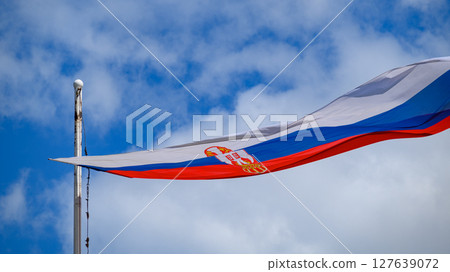 Huge Flag of Serbia flapping in the wind on a flagpole 127639072