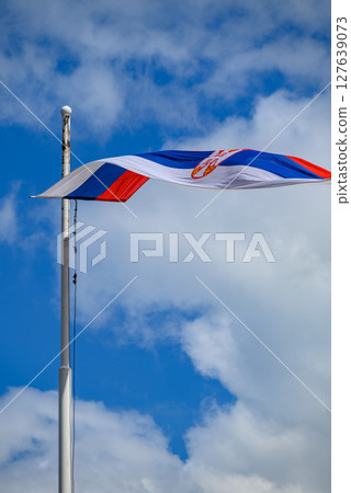 Huge Flag of Serbia flapping in the wind on a flagpole 127639073