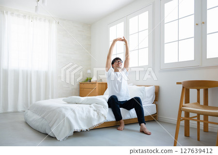Men sitting on bed 127639412
