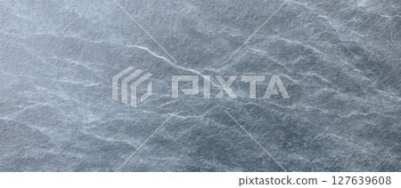 Travertine leathered stone with fine natural white veins and cool gray tones 127639608