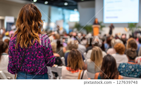 Diverse conference audience watching speaker from stage perspective at business event 127639748
