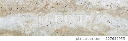 Travertine natural stone surface with light beige veins and porous structure 127639955