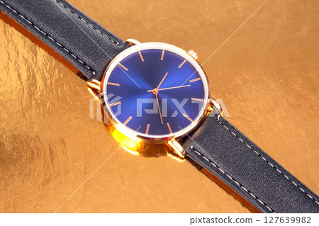 Gold wrist watch with blue dial 127639982