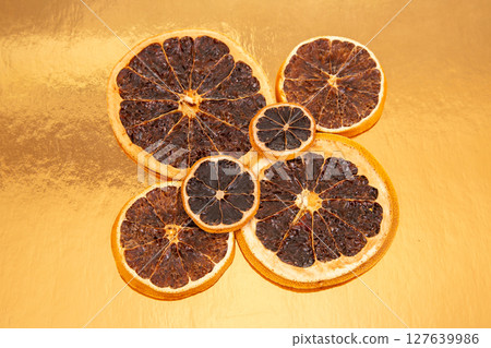 mix different pieces of dried citrus fruit on a plate 127639986