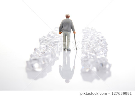 miniature figure in a gray suit walks through a dazzling crystal-lined path on a reflective surface, miniature figure in a gray suit walks through a dazzling crystal-lined path on a reflective surface, 127639991