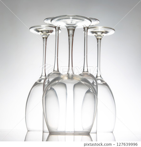Elegant empty wine glasses with delicate stems arranged neatly, 127639996
