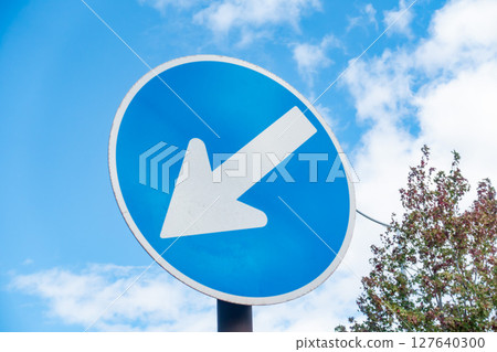 A photo of a sign prohibiting traffic in any direction other than the specified direction. Traffic image. 127640300