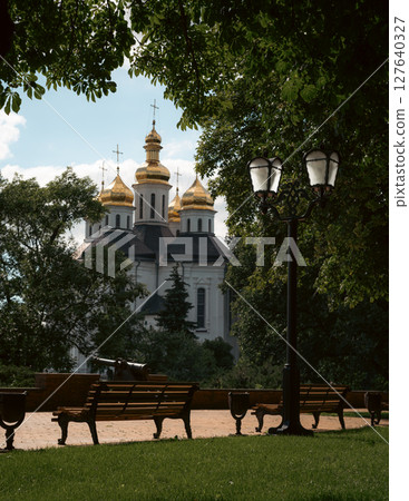 The peaceful park setting enhances the spiritual aura of the scene. 127640327