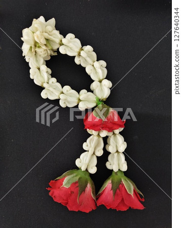 Thai flower garland on black background. 127640344