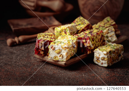 Traditional Turkish delight on an old brown table. Traditional Turkish delight on an old brown table. 127640553