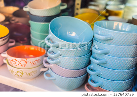 Colorful ceramic soup bowls on display. Kitchen decor, pastel dishware, and vibrant tableware with vintage flair. Colorful ceramic soup bowls on display. Kitchen decor, pastel dishware, and vibrant tableware with vintage flair. 127640759