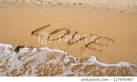 Love written on sandy beach with ocean waves approaching Love written on sandy beach with ocean waves approaching 127640967