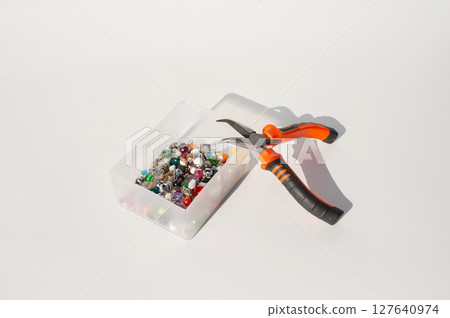 Craft beads and pliers on table for jewelry making Craft beads and pliers on table for jewelry making 127640974