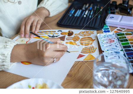 Humorists are Artists Month. Artist Painting Colorful Autumn Motifs on Paper 127640995