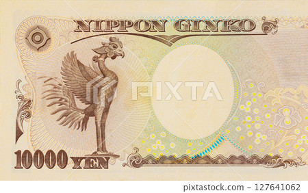 10000 yen banknote showing intricate details of phoenix, used in Japanese currency. 127641062