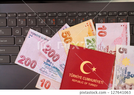 Lira banknotes currency passport of Turkey arranged neatly, showcasing blend of travel documentation local money. Lira banknotes currency passport of Turkey arranged neatly, showcasing blend of travel documentation local money. 127641063