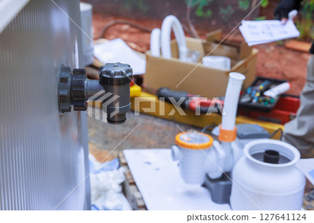 Installation process of water pump filter tank system at residential swimming pool during works maintenance 127641124