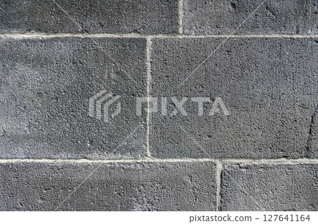 Old wall made of large gray blocks. Horizontal photo. Background 127641164