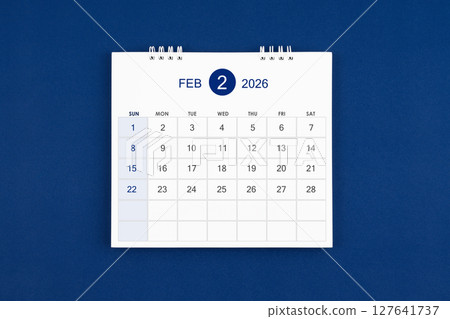 February 2026 Monthly desk calendar on navy blue color leather background. 127641737