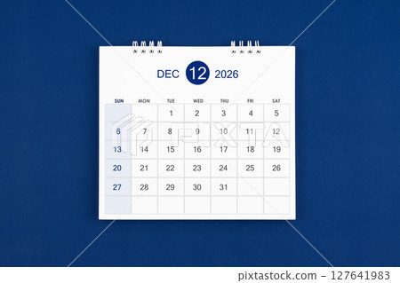 December 2026 Monthly desk calendar on navy blue color leather background. 127641983
