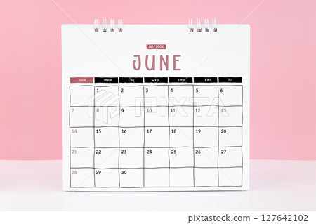 Desk calendar for June 2026 on a pink color background with copy space. 127642102
