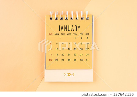 January 2026 mini desk calendar on the yellow, planning for business meeting concept. January 2026 mini desk calendar on the yellow, planning for business meeting concept. 127642136
