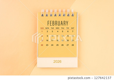 February 2026 mini desk calendar on the yellow, planning for business meeting concept. February 2026 mini desk calendar on the yellow, planning for business meeting concept. 127642137