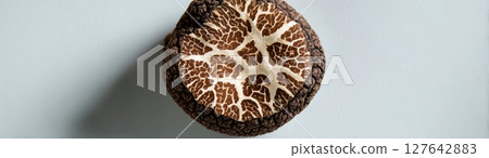 Top-down macro of black truffle surface showing intricate organic texture and detailed pattern 127642883