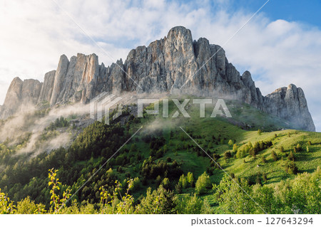 Bolshoy Tkhach mount with fog and evening sunlight. The Caucasus Mountains. Bolshoy Tkhach mount with fog and evening sunlight. The Caucasus Mountains. 127643294