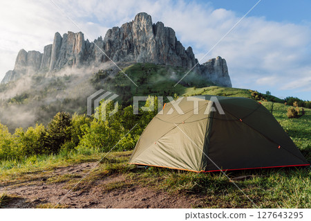 Scenic camping spot in the mountains with a tent at sunrise, Bolshoy Tkhach national park 127643295